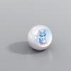 Round white device with a cartoon character inside on a gray background